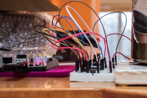 Breadboards, jumper wires, sensors and electrical components on a desk.